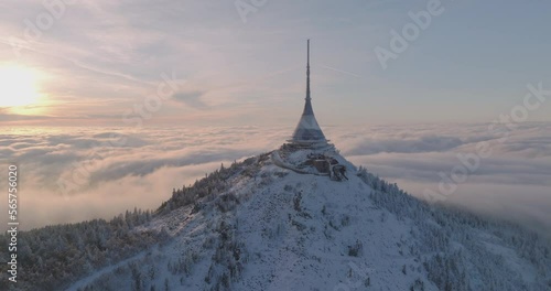 Jested tower mountain hill with snow mist and fog at golden hour