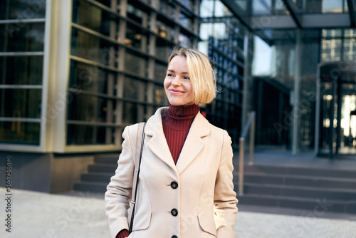 A smiling pretty middle-aged businesswoman outside an office building. Cheerful corporate people. High quality photo © CarlosBarquero