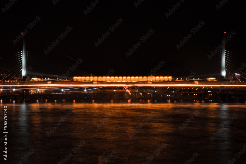 Fototapeta premium Istanbul Golden Horn Metro Bridge at night with the lights of the city. Also known as Ataturk Bridge