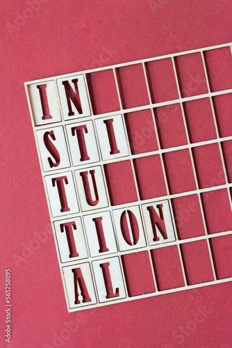 institutional (hyphenated) and wooden grid on red paper photo