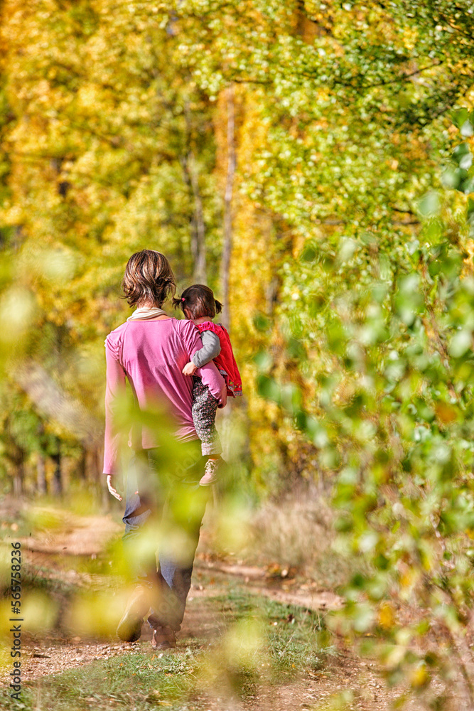Mother and daughter near the river in autumn Escabas. Cañamares, Strait of Priego, Castilla la Mancha, Spain Mother and daughter near the river in autumn Escabas. Cañamares, Strait of Priego, Castilla la Mancha, Spain
