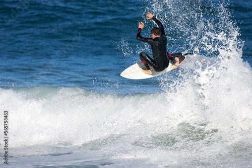 A young man surfing at Rebounds, on the South Arm Peninsular, in Tasmania. photo