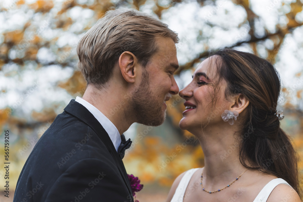 Young Wedding Couple looking at each other in fall park. High quality photo Young Wedding Couple looking at each other in fall park. High quality photo