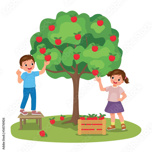 happy little kids boy and girl picking apples fruits from the tree in the orchard garden