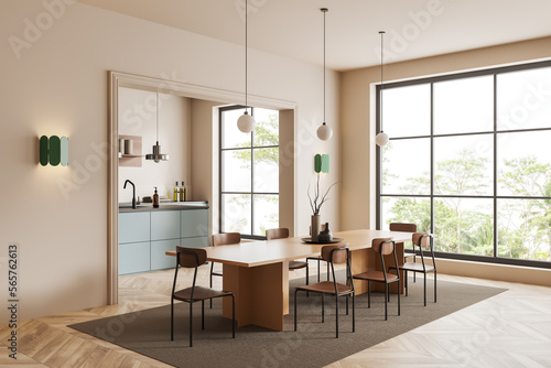 Modern kitchen interior with dining table and cooking corner, panoramic window