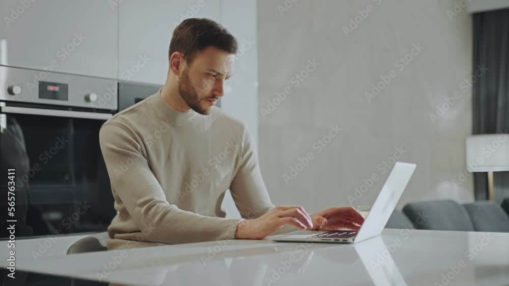Slow-motion shot of a young man working from home on his laptop and typing on keyboard in self-isolation, quarantine. Stay home concept Slow-motion shot of a young man working from home on his laptop and typing on keyboard in self-isolation, quarantine. Stay home concept