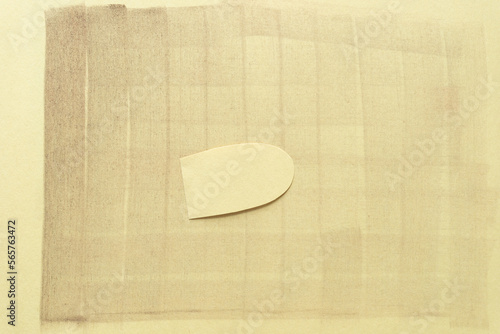 Fotografie rounded paper shape isolated on a smudgy yellow paper background