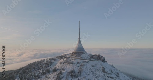 Jested tower mountain hill with snow mist and fog at golden hour