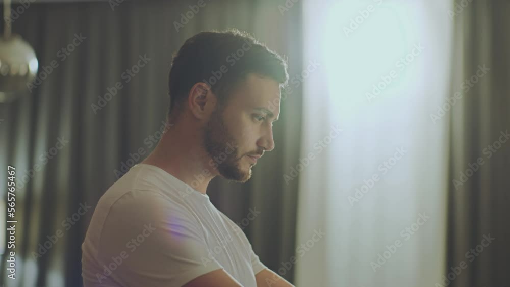 Remote work concept. Concentrated young man smiling and working online on laptop, reading e-mail, tracking shot Remote work concept. Concentrated young man smiling and working online on laptop, reading e-mail, tracking shot