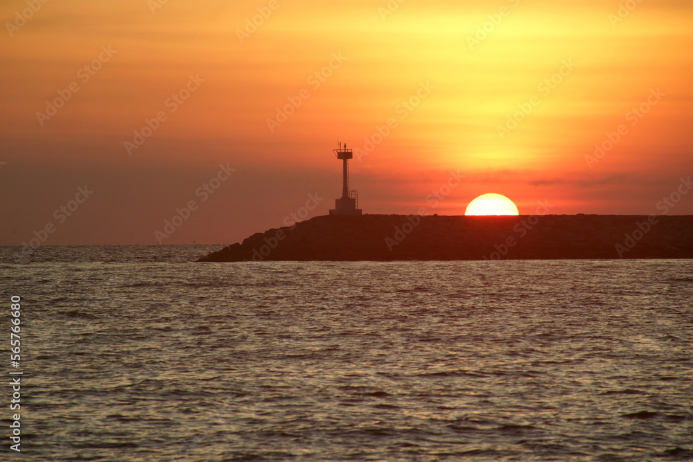 lighthouse with beautiful sunset and the ocean background