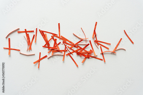 short orange paper stripes or lines scattered on blank paper
