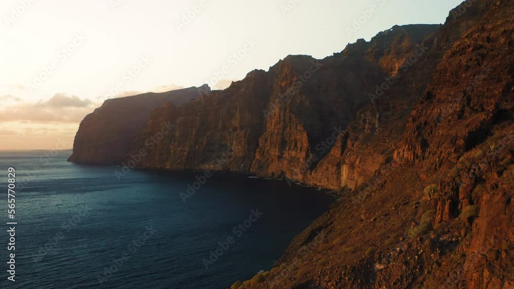 Last sunset light on mountain cliffs in dark night deep ocean background. Los Gigantes Tenerife. Last sunset light on mountain cliffs in dark night deep ocean background. Los Gigantes Tenerife.