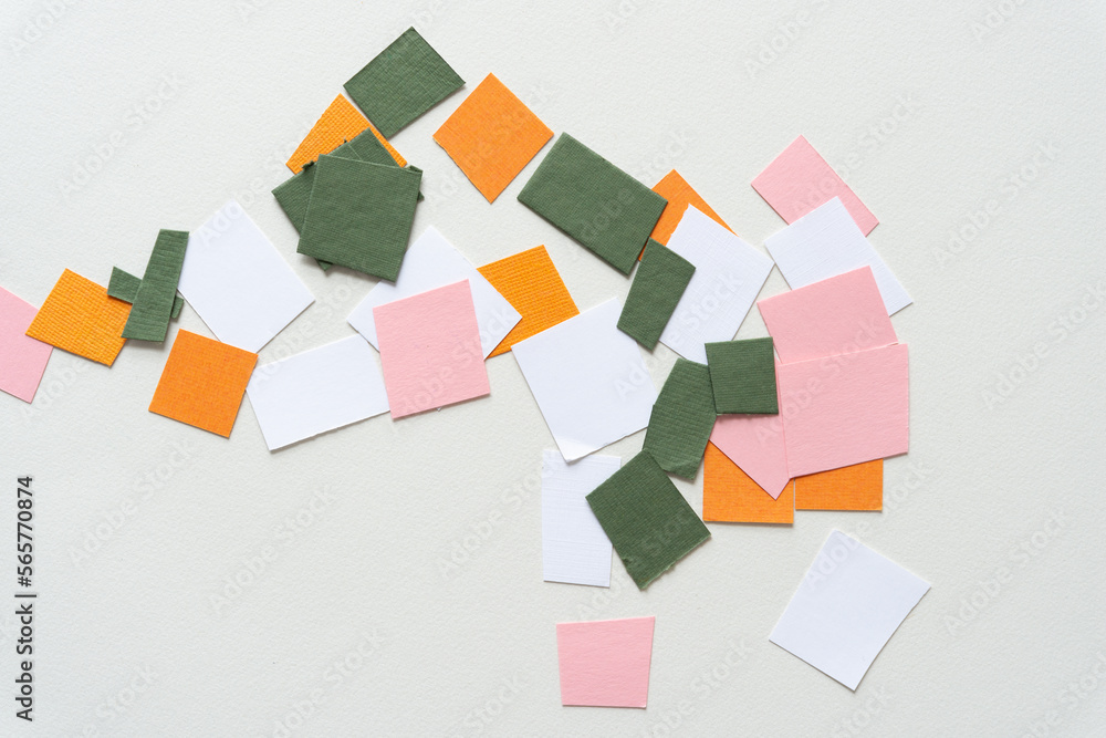 cut green, orange, white, and pink paper shapes on blank paper