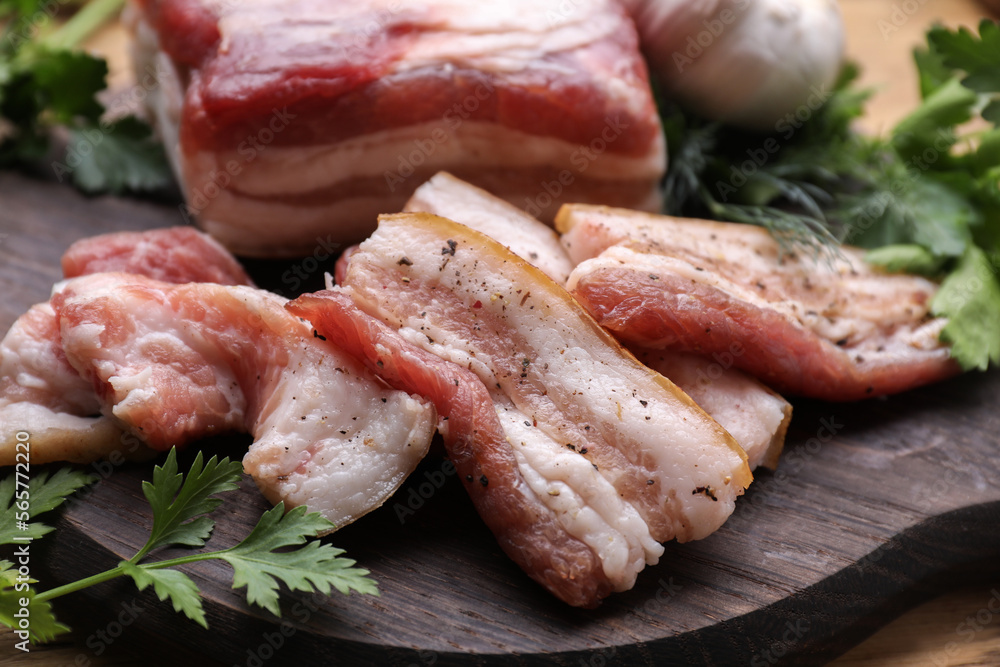 Pork fatback and fresh parsley on wooden table, closeup Pork fatback and fresh parsley on wooden table, closeup