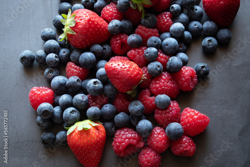 Fototapeta Naklejka Na Ścianę i Meble -  Blueberries, raspberries and strawberries on black background 