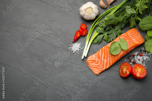 Fresh salmon and ingredients for marinade on black table, flat lay. Space for text
