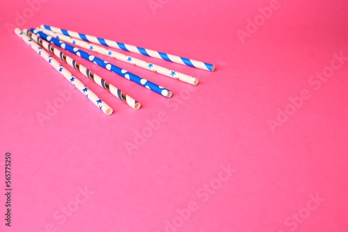 Colorful paper drinking straws on pink background. Space for text