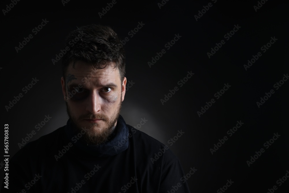Man with bruise on dark background, space for text. Hostage Man with bruise on dark background, space for text. Hostage