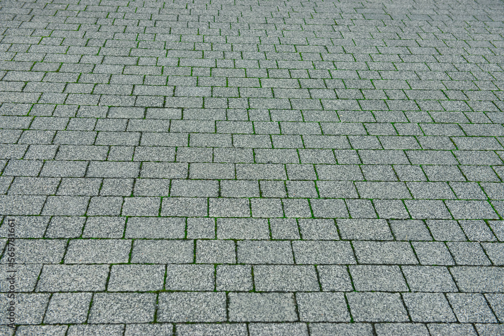 View on grey stone sidewalk. Footpath covering