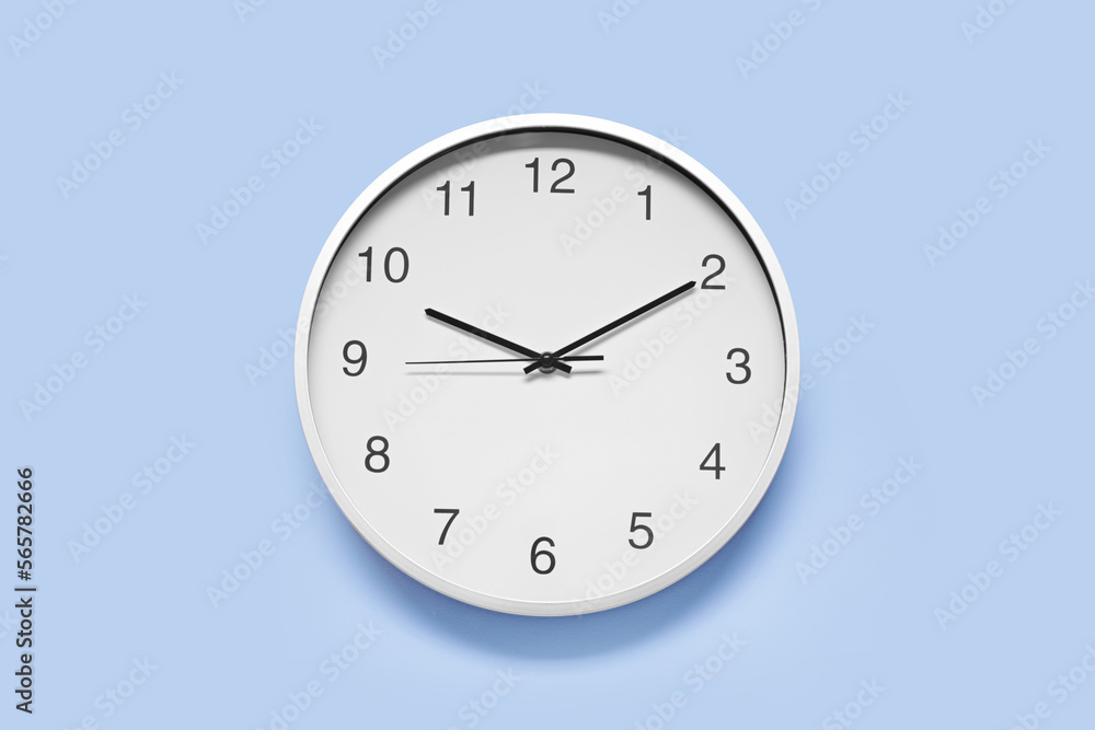 Stylish round clock on light blue background, top view. Interior element Stylish round clock on light blue background, top view. Interior element