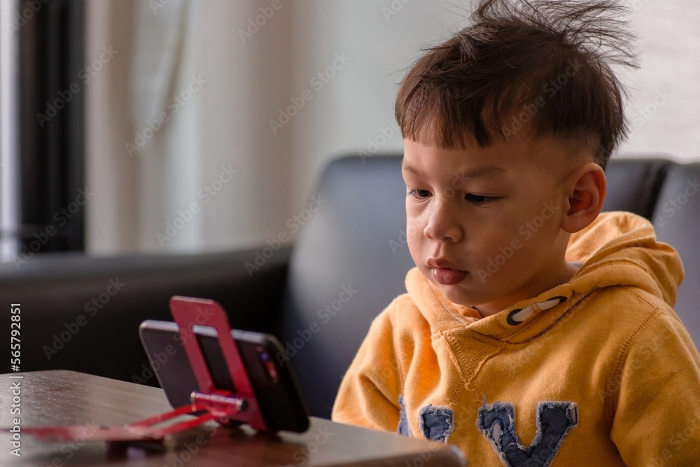 KiD boy looking a smart phone