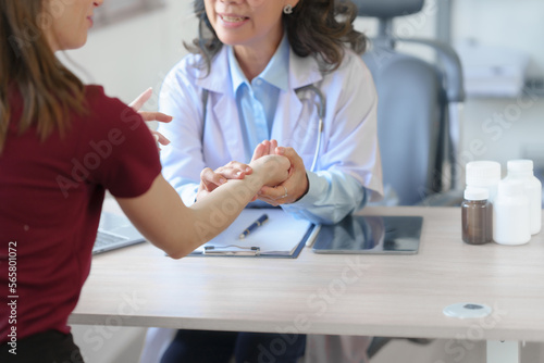 Elderly Asian female nurses instruct caucasian patients with orthopedics and educate them on orthopedic care or take pulse to check heart rate per minute. to look for abnormal symptoms