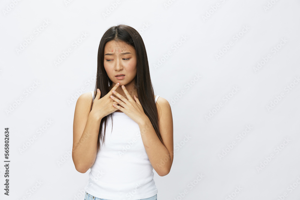 Asian woman facial skin problems, acne and inflammation, red rashes and allergies, chicken pox, sadness from rashes. Facial skin care concept for diseases and nerves Asian woman facial skin problems, acne and inflammation, red rashes and allergies, chicken pox, sadness from rashes. Facial skin care concept for diseases and nerves