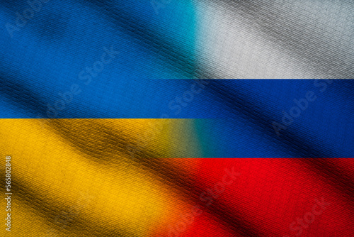 Half of Ukraine flag and Russia flag  on silk fabric for both countries political conflict and war concept.