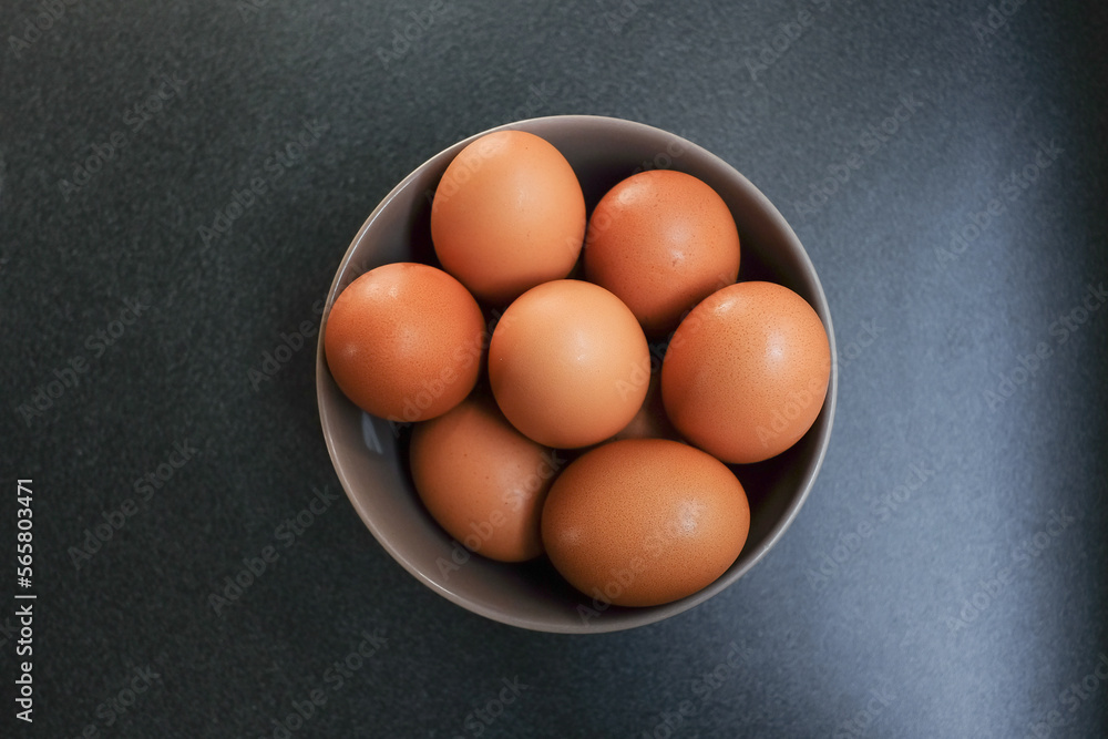 Top view of eggs in bowl on dark background. Top view of eggs in bowl on dark background.