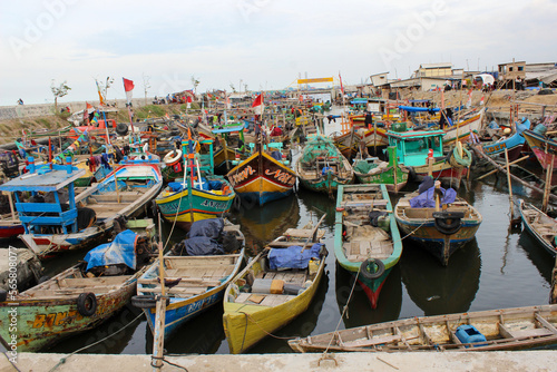 Traditional fishing boats are parked on the edge of the fishing village