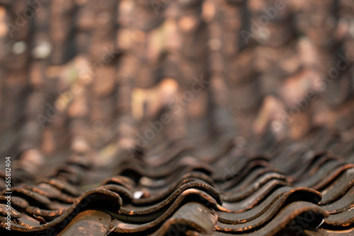 close up of old terracotta roof tiles textured, traditional cover in Indonesia blurred