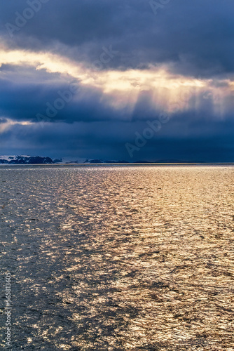 Storm clouds over the sea with sun sparkles