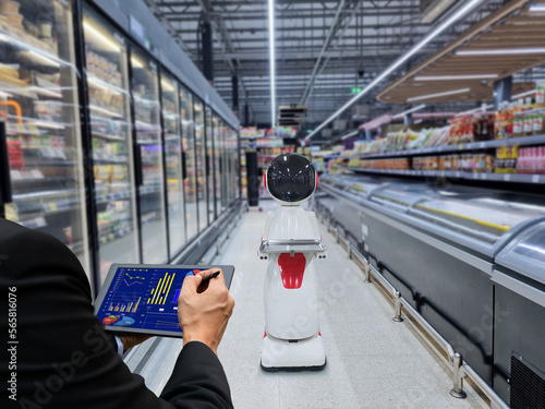 Businessman holding tablet controlling robot Innovative shopping robots in the supermarket lol