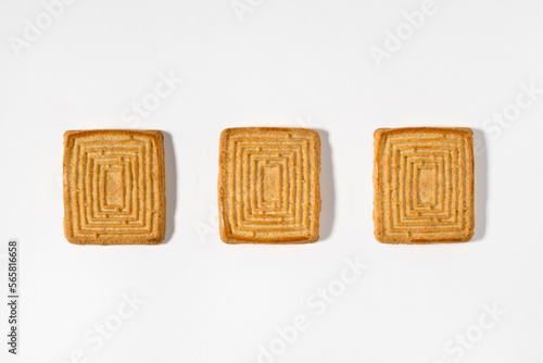 Three biscuits in row on white background