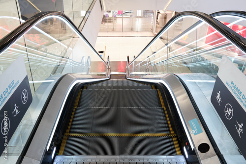 Close-up of an escalator in a modern shopping mall.