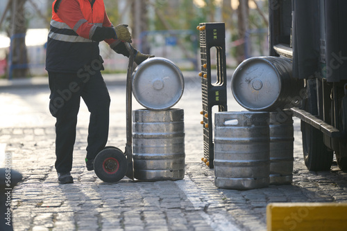 Man delivering beer kegs in Malaga, Spain