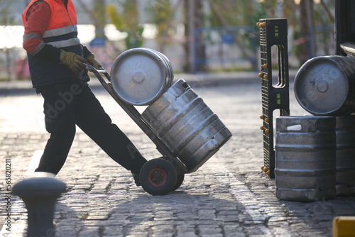 Man delivering beer kegs in Malaga, Spain