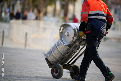 Man delivering beer kegs in Malaga, Spain