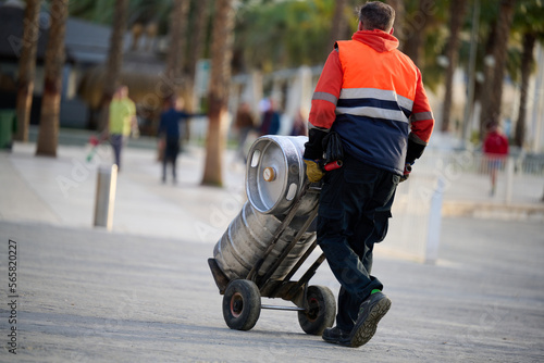 Man delivering beer kegs in Malaga, Spain