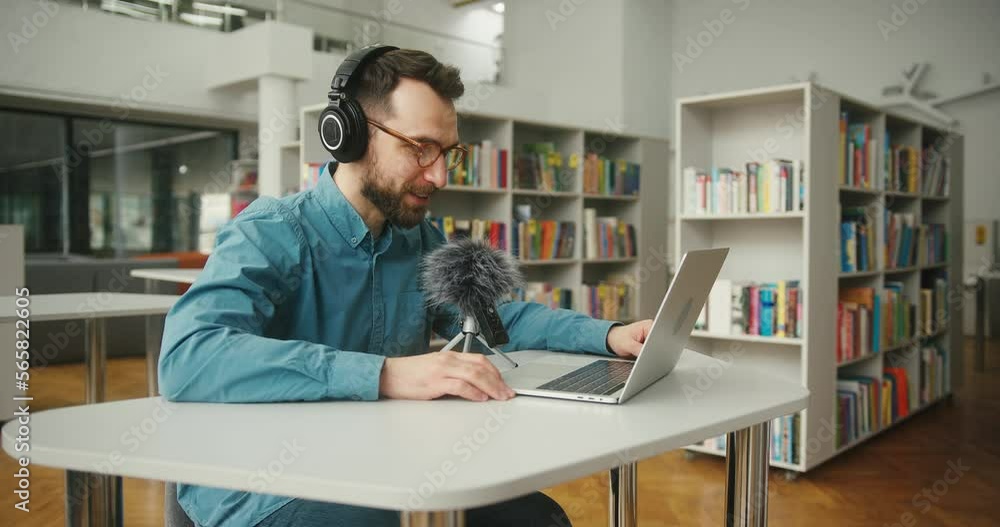 Bearded man conducts online meeting with colleagues at table Bearded man conducts online meeting with colleagues at table
