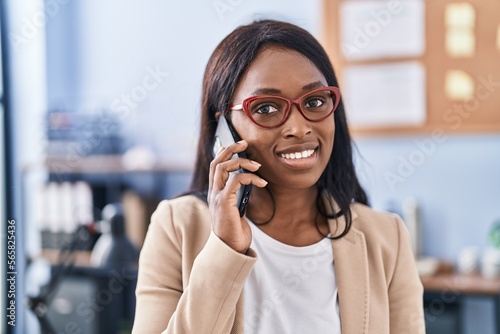 Young african american woman business worker talking on the smartphone at office