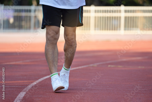 healthy senior man running in sport stadium, concept for elderly people health care, lifestyle, workout ,wellbeing