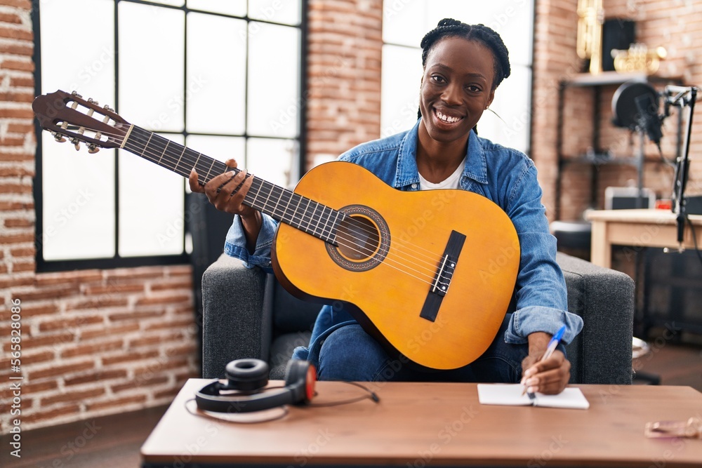 African american woman musician composing song playing classical guitar at  music studio Stock Photo | Adobe Stock