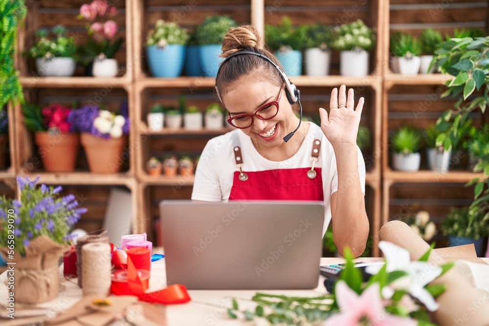 Young hispanic woman working at florist shop doing video call looking positive and happy standing and smiling with a confident smile showing teeth Young hispanic woman working at florist shop doing video call looking positive and happy standing and smiling with a confident smile showing teeth