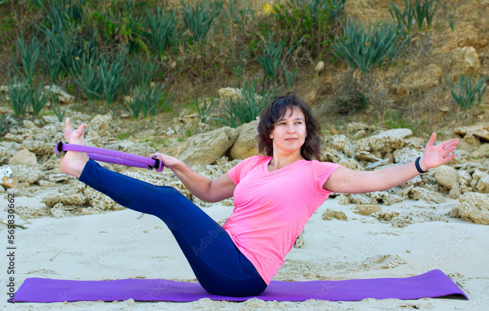 Woman doing yoga on a beach