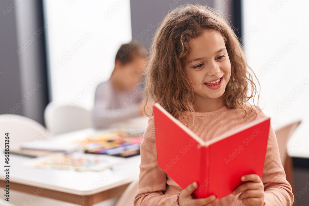 Two kids students reading book studying at classroom Two kids students reading book studying at classroom