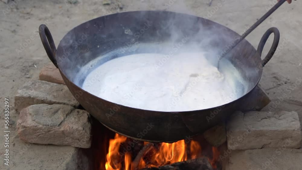 cooking milk on the stove, milk boiling for khoya cooking milk on the stove, milk boiling for khoya