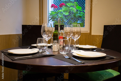 Elegant restaurant table with cutlery, crockery and glasses.