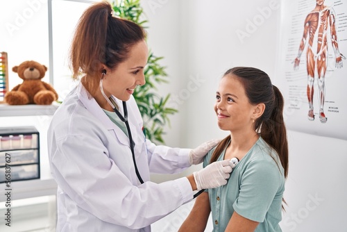 Photography Woman and girl doctor and patient auscultating chest at clinic