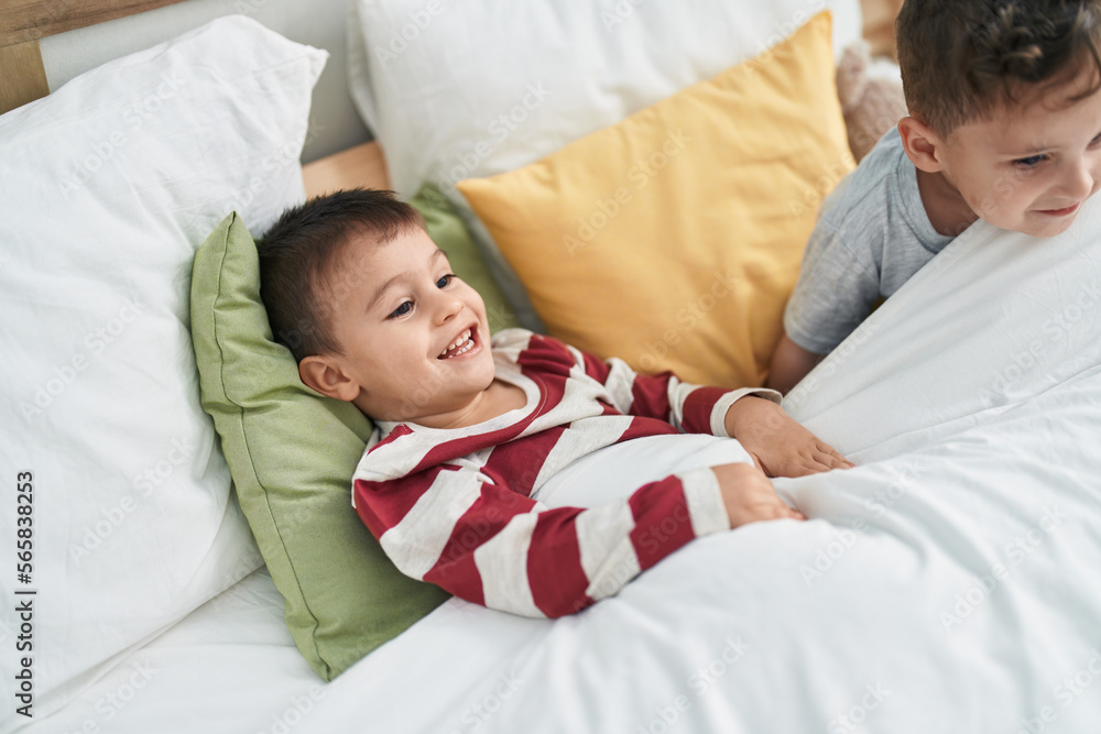 Two kids smiling confident lying on bed at bedroom Two kids smiling confident lying on bed at bedroom